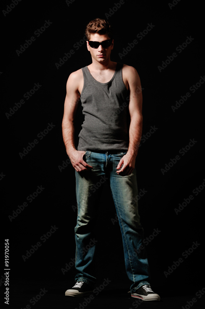 picture of stylish young man in sunglasses posing for the camera picture of stylish young man in sunglasses posing for the camera