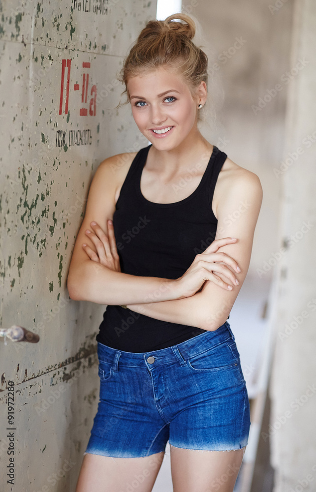 Woman in jeans shorts and black shirt. Woman in jeans shorts and black shirt.