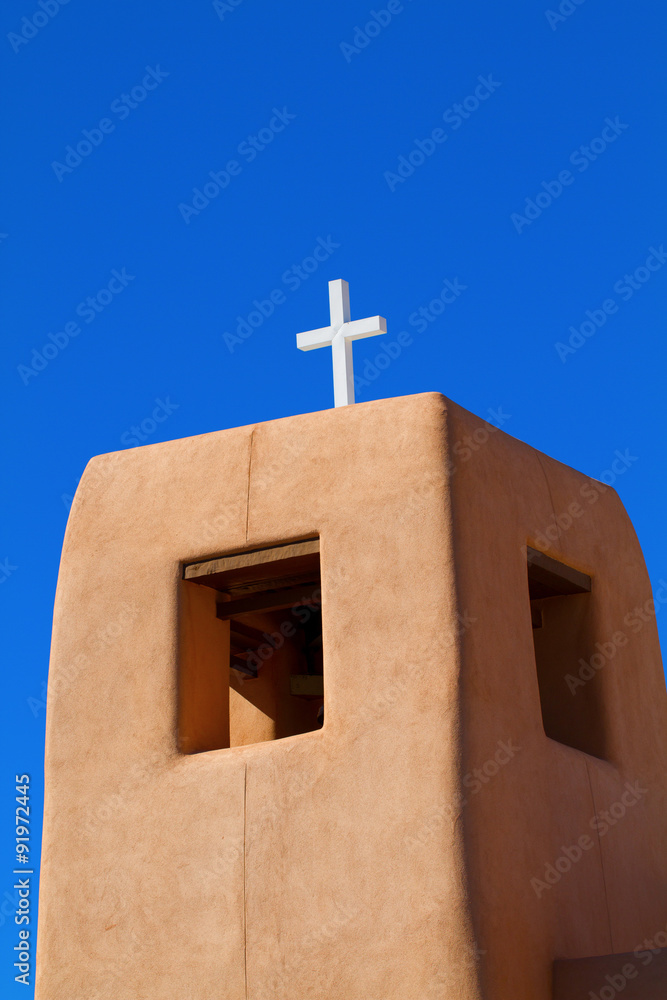 Traditional New Mexico church tower with blue sky in Santa Fe, New Mexico Traditional New Mexico church tower with blue sky in Santa Fe, New Mexico