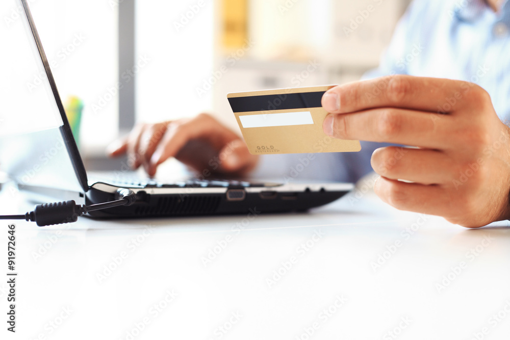 Fototapeta premium Close Up Of A Man Shopping Online Using Laptop With Credit Card