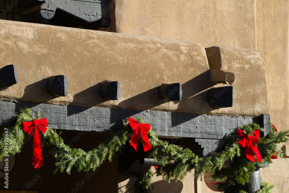 Fototapeta premium Green boughs and red bows make Santa Fe, New Mexico, festive at Christmastime