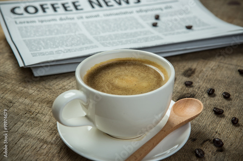 Close up glasses on newspaper and Coffee on the wooden table in