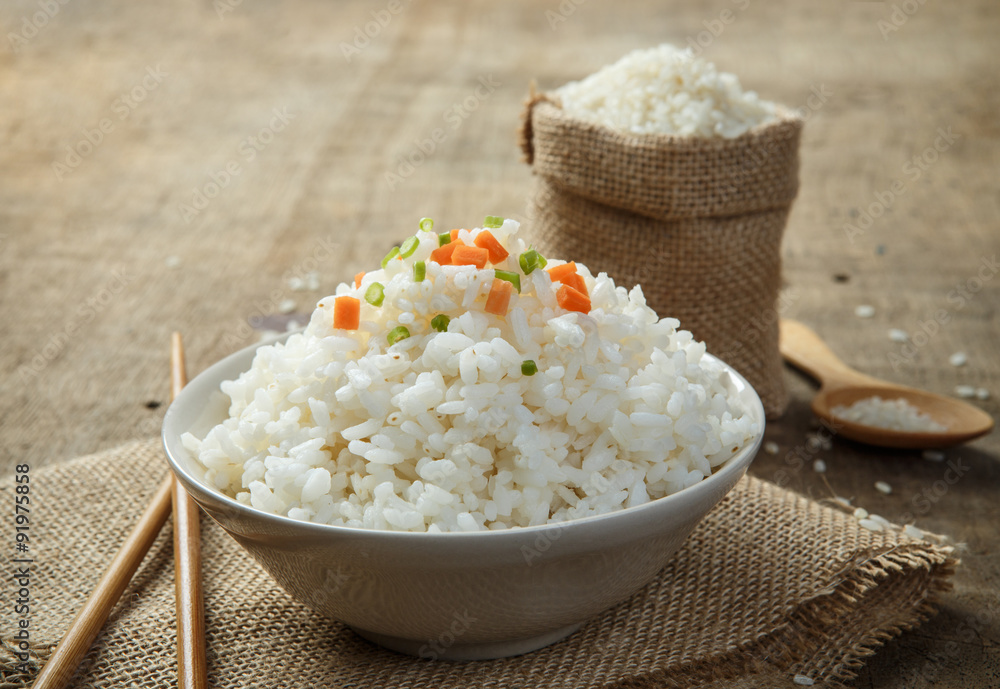 Steamed rice close-up with chopsticks on burlap Steamed rice close-up with chopsticks on burlap