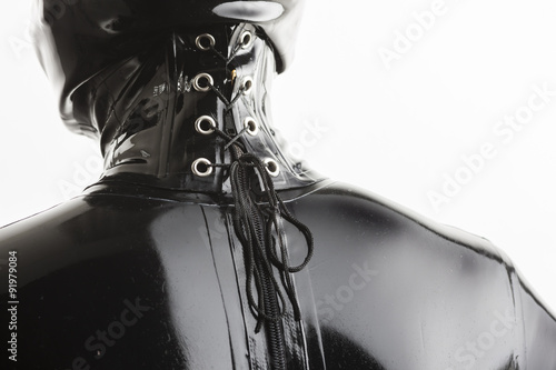 detail of standing woman wearing latex clothes photo
