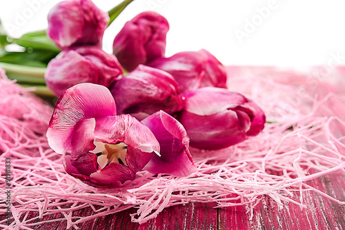 red tulips on wooden background