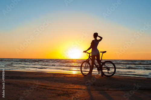 Moment in time. Sporty woman cyclist silhouette on multicolored