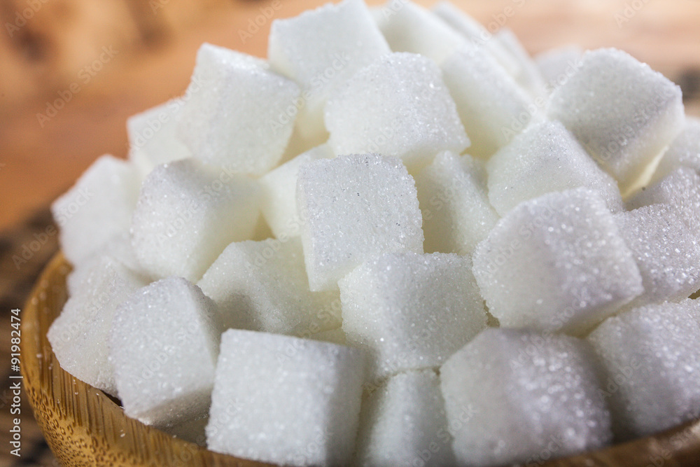 Pile of Sugar Cubes over Wooden Background Pile of Sugar Cubes over Wooden Background