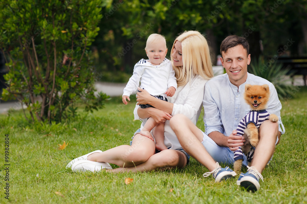 Fototapeta premium Happy young family spending time together in green nature