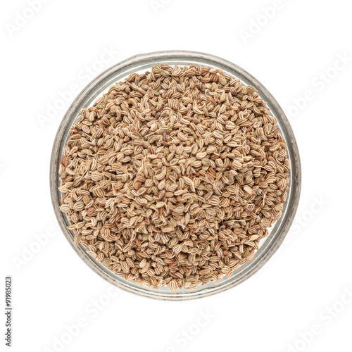 Top view of Organic Ajwain (Trachyspermum ammi) in glass bowl isolated on white background.