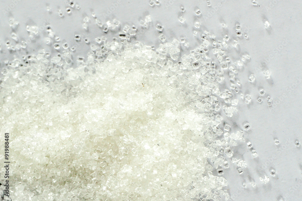 Closeup of white granulated sugar on Isolated White Background Closeup of white granulated sugar on Isolated White Background