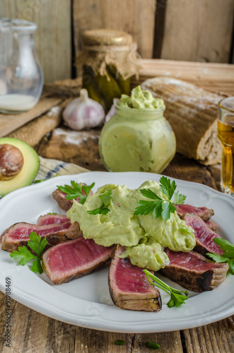 Beef steak with avocado dip and herbs