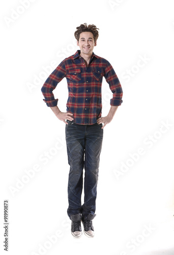young casual man jumping for joy on white background