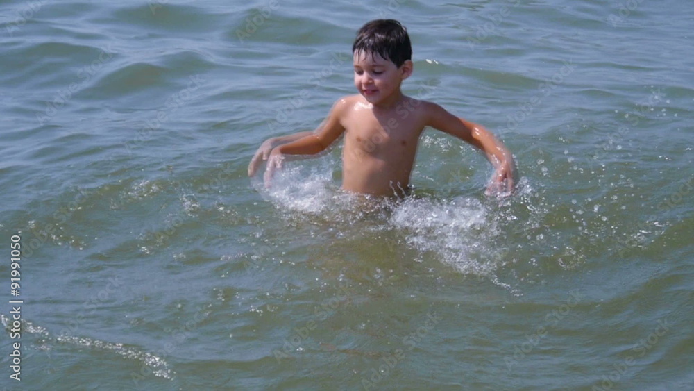 a little boy having fun in the sea on the waves a little boy having fun in the sea on the waves