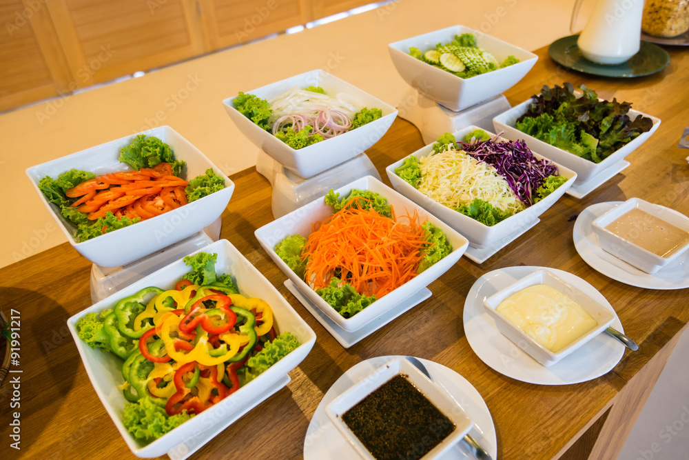Salad bar with a variety of vegetables served buffet. Salad bar with a variety of vegetables served buffet.