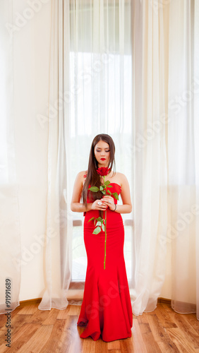 portrait of a beautiful blonde with red rose © Andriy Petrenko