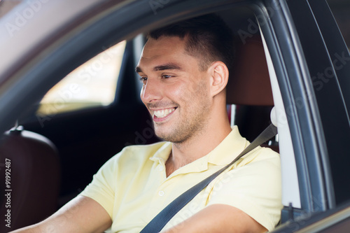 happy smiling man driving car outdoors