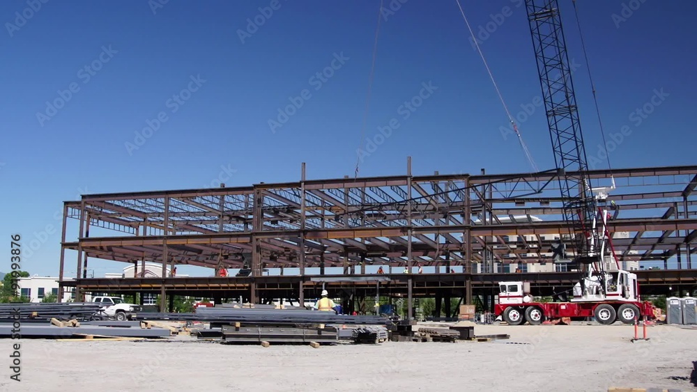 Crane Lifts Steel Beam at Construction Site Crane Lifts Steel Beam at Construction Site
