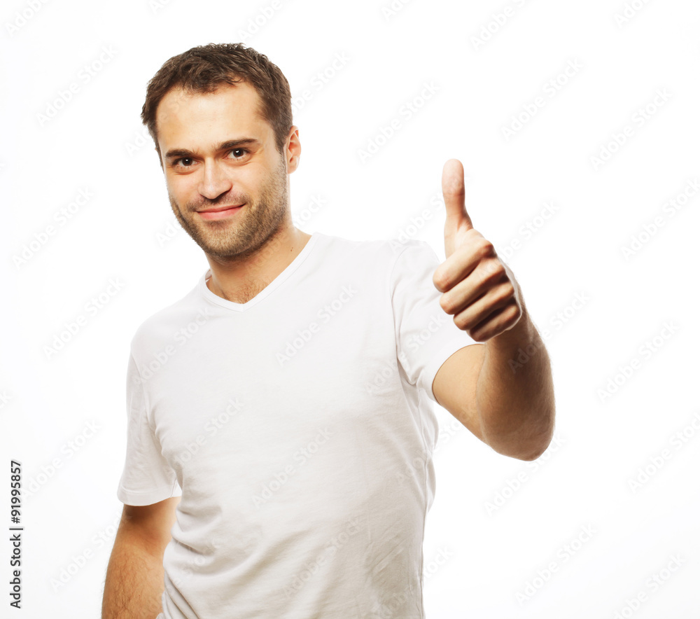Happy handsome man showing thumbs up Happy handsome man showing thumbs up