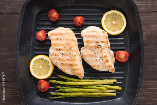 Marinated grilled chicken breasts cooked BBQ on a pan