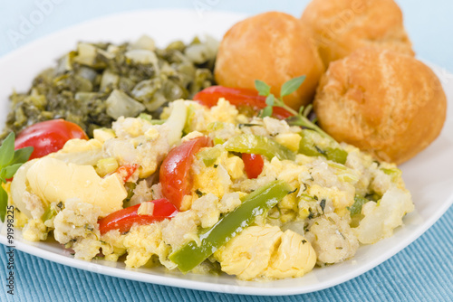 Ackee & Saltfish - Traditional Jamaican dish made of salt cod and ackee fruit. Served with callaloo and johnny cakes.
