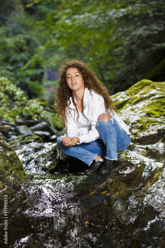 Young European woman hiker by the river, outdoors activities