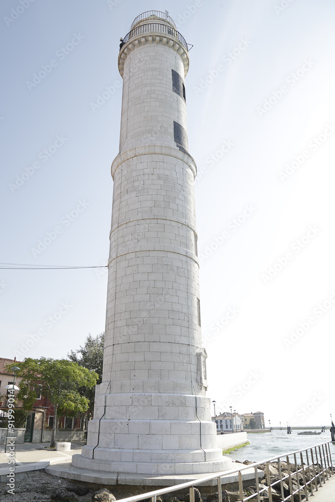 Ancient white lighthouse on the island of Murano near Venice, Italy