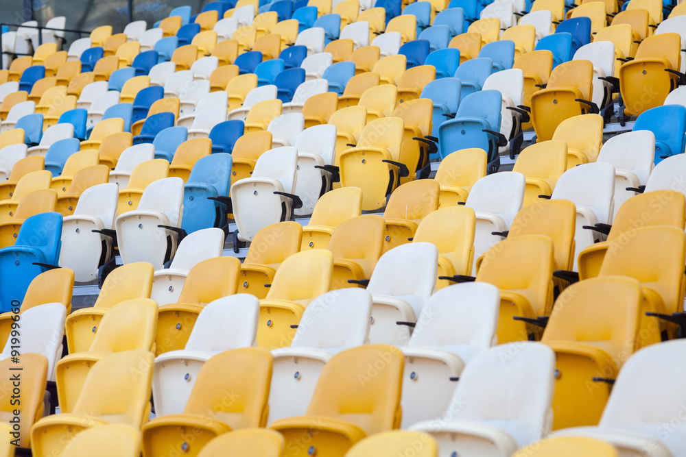 Fototapeta premium Close-up view of white, red and yellow stadium seats on Olympic stadium