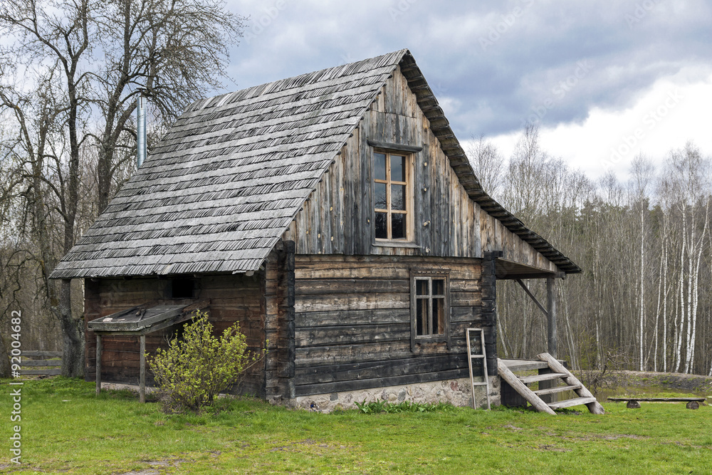 Lonely log cabin surrounded by rural landscape Lonely log cabin surrounded by rural landscape