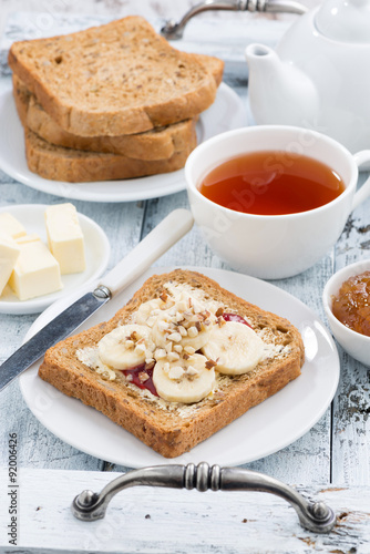 toast with peanut butter and banana, fresh black tea, vertical