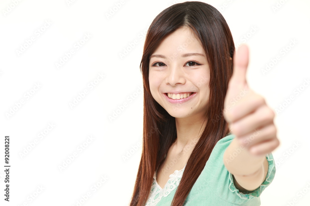 young Japanese woman with thumbs up gesture young Japanese woman with thumbs up gesture
