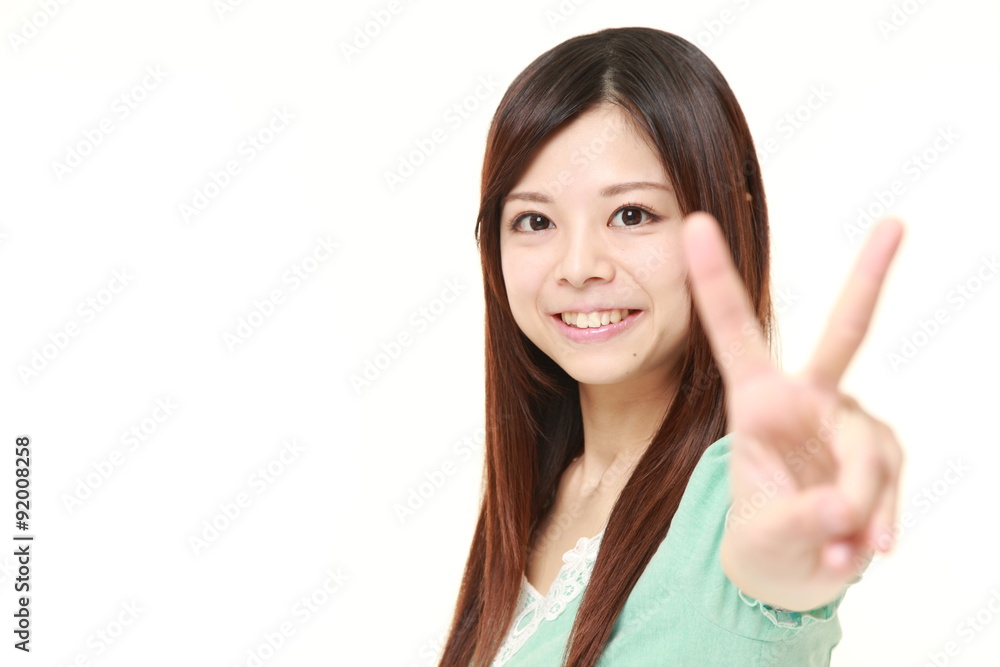 young Japanese woman showing a victory sign young Japanese woman showing a victory sign