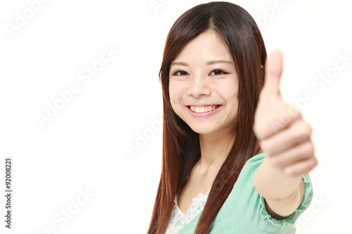  young Japanese woman with thumbs up gesture