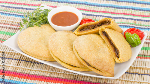 Photos Caribbean Jerk Beef Patty - Jamaican spicy minced jerk beef with onions and peppers in short crust pastry served with spicy sauce and scotch bonnet chillies