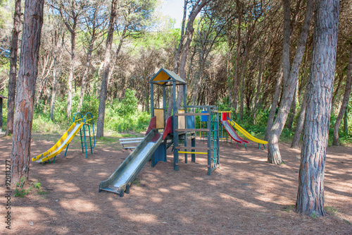 Playground with colored slide in a forest