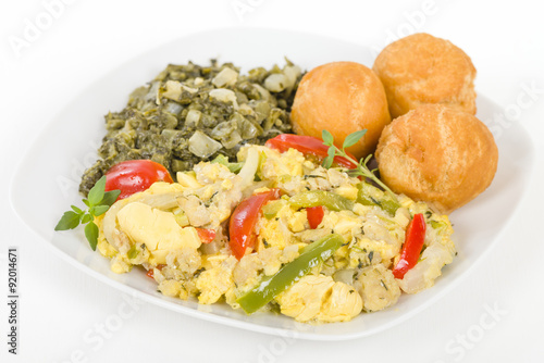 Ackee & Saltfish - Traditional Jamaican dish made of salt cod and ackee fruit. Served with callaloo and johnny cakes.
