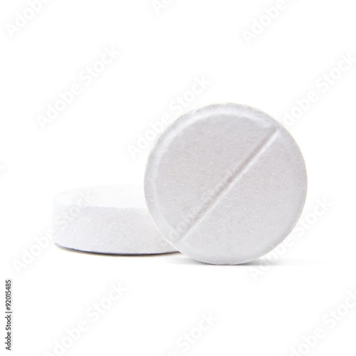 Macro shot of two medical round pills isolated on white