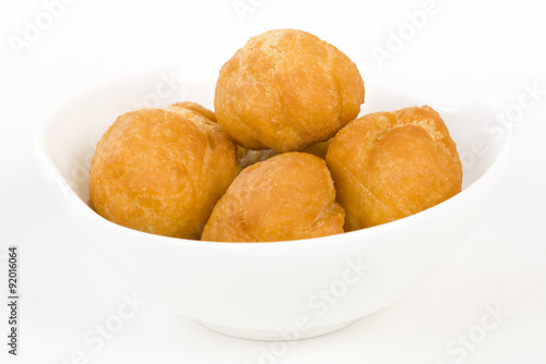 Johnny Cakes - Jamaican fried dumplings in a white bowl.
