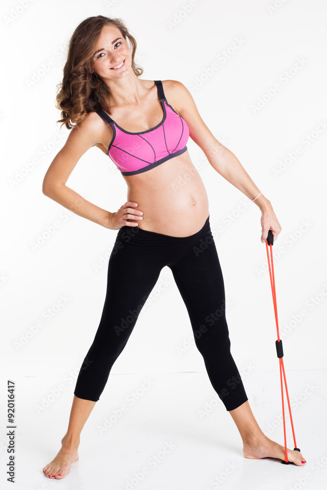 Pregnant woman doing sport with resistance band Pregnant woman doing sport with resistance band