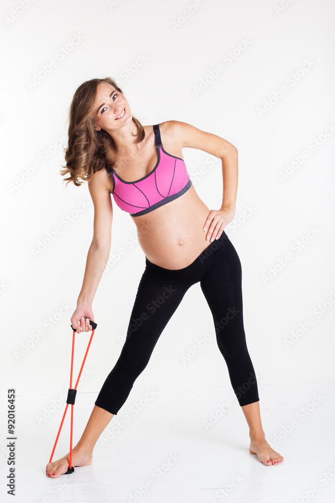Pregnant woman doing sport with resistance band Pregnant woman doing sport with resistance band