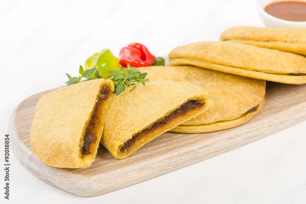 Caribbean Jerk Beef Patty - Jamaican spicy minced jerk beef with onions and peppers in short crust pastry served with spicy sauce and scotch bonnet chillies.
Caribbean Jerk Beef Patty - Jamaican spicy minced jerk beef with onions and peppers in short crust pastry served with spicy sauce and scotch bonnet chillies.