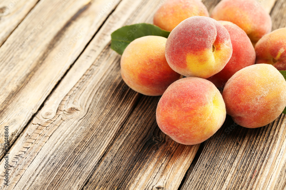 Ripe peaches fruit on a brown wooden background