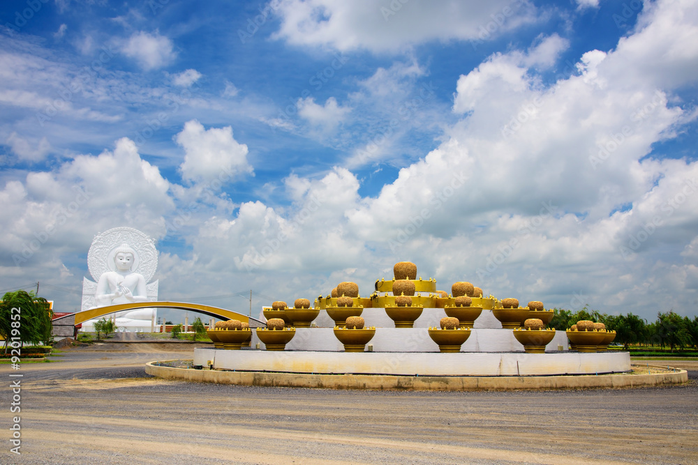 Fototapeta premium White Buddha statue against blue sky