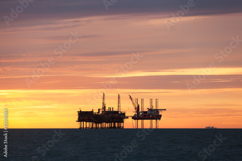 Silhouette of oil platform at sunset © Lukasz Z
