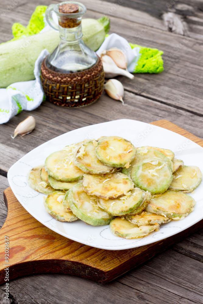 Fried zucchini with garlic in a bowl on a table