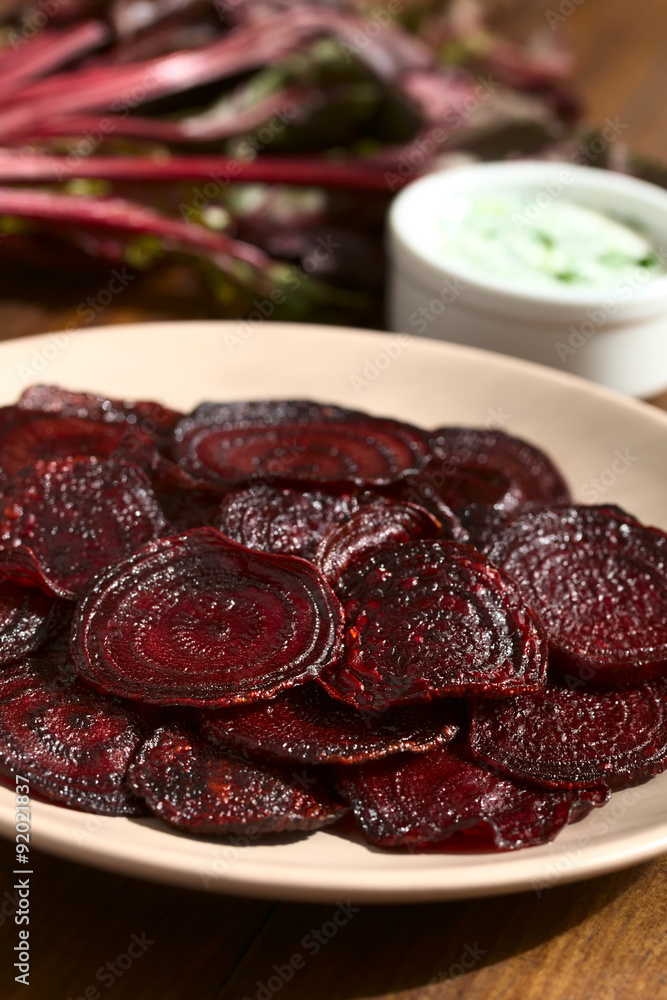 Fresh homemade beetroot chips on plate, photographed with natural light (Selective Focus, Focus one third into the image)