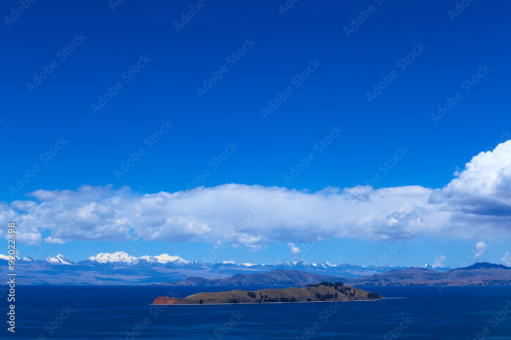 The Isla de la Luna (Island of the Moon) with the snow-capped mountains of the Andes in the back photographed from the Isla del Sol (Island of the Sun) in Lake Titicaca, Bolivia