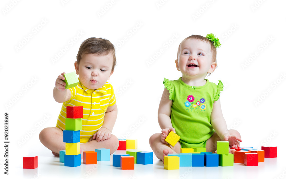Two adorable kids playing with toys. Toddlers girl and boy Two adorable kids playing with toys. Toddlers girl and boy