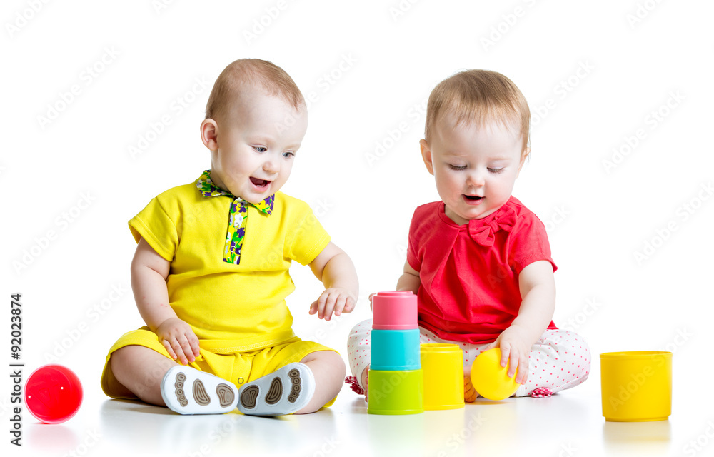 Cute kids playing with color toys. Children girl and boy sitting Cute kids playing with color toys. Children girl and boy sitting