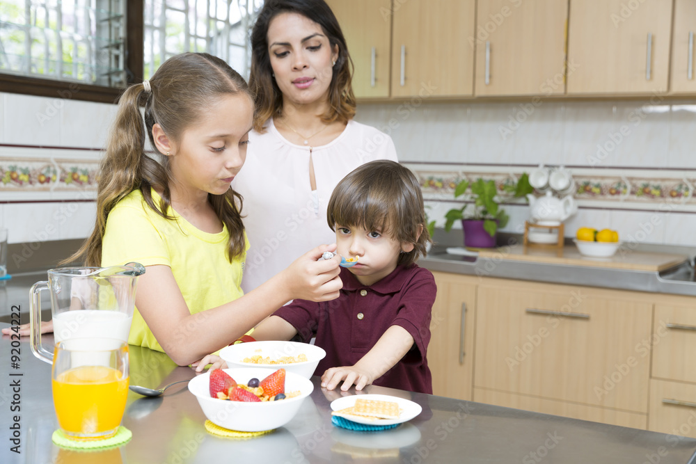 Lovely Mother and her children having breakfast Lovely Mother and her children having breakfast