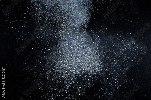 abstract white dust explosion on black background. abstract white powder explosion on black background. abstract texture.